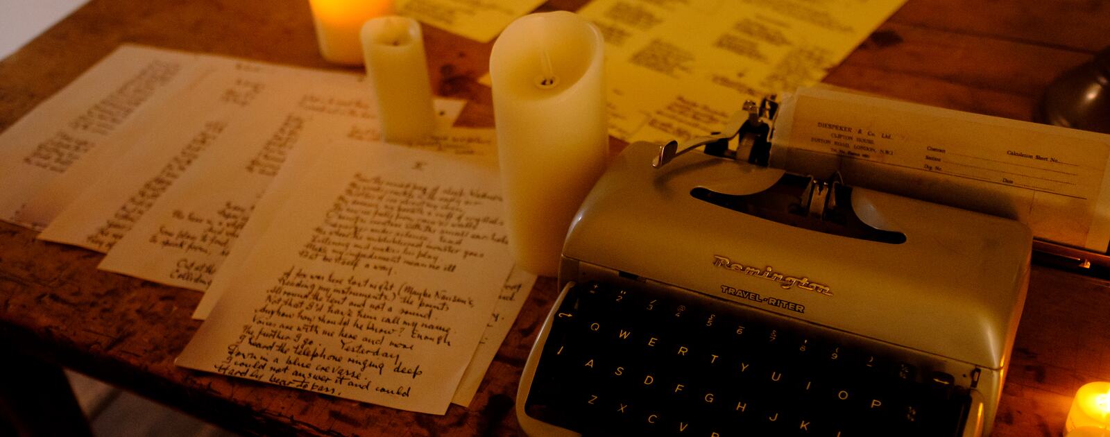 Constructing Spaces, image of typewriter and lit candles on a desk