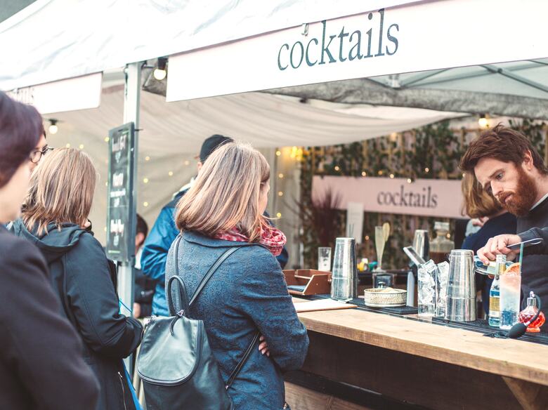 Photo of people looking as a bartender prepares a drink at Honest Folk Cocktail Bar at Southbank Centre