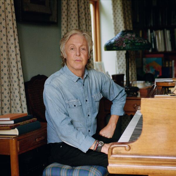 Paul McCartney, artist, pictured by a piano