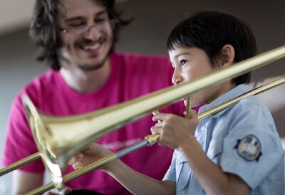 Child playing the trumpet at a workshop