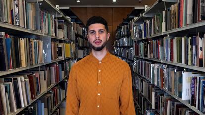 Poet Anthony Anaxagorou stands in the National Poetry Library at Southbank Centre