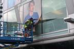 Installing Tom (2020) by Lydia Blakeley, on the windows of Southbank Centre’s Liner Building, overlooking Mandela Walkway.
