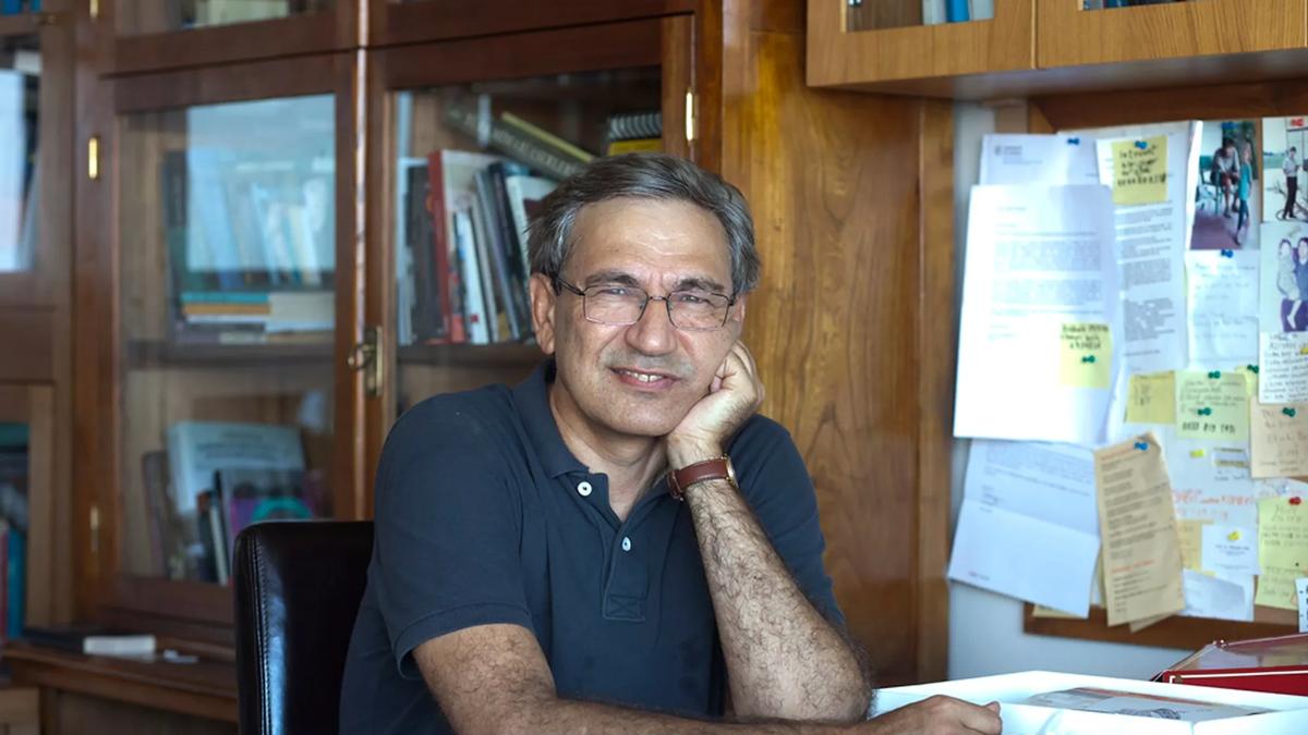 Portrait of writer Orhan Pamuk sitting at his desk