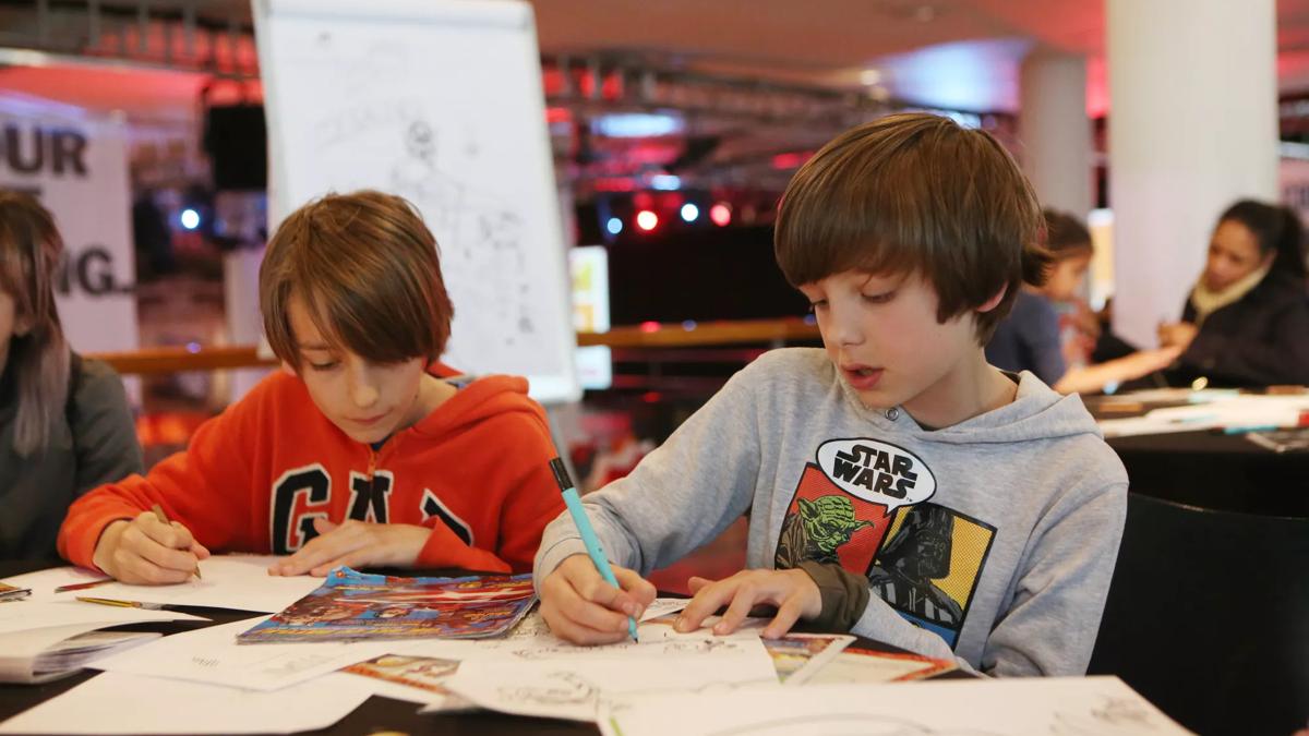 Two Boys at a workshop sketching comics