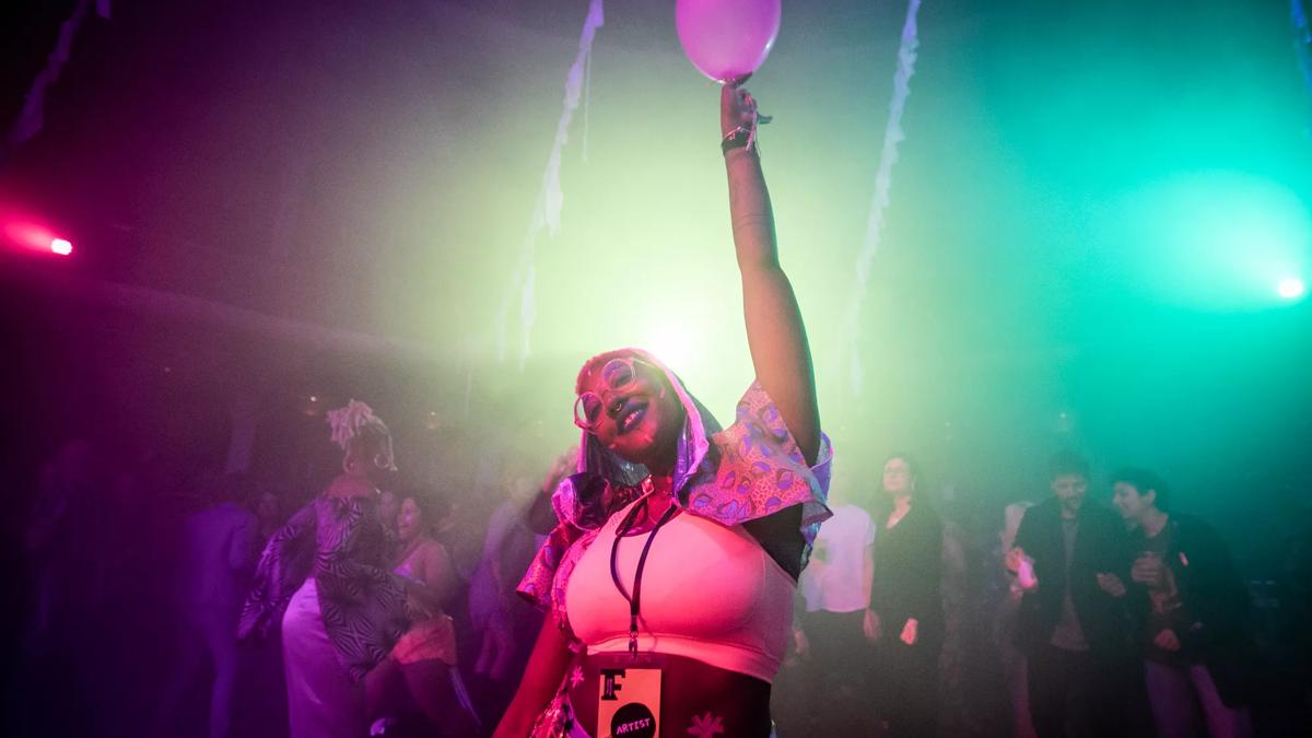 Partygoer holding up a balloon