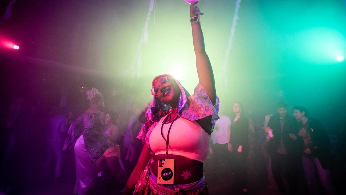 Partygoer holding up a balloon