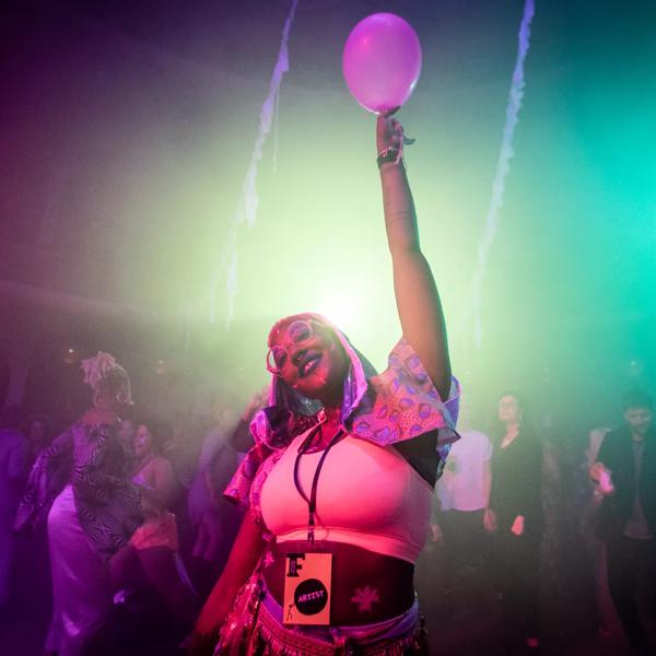 Partygoer holding up a balloon
