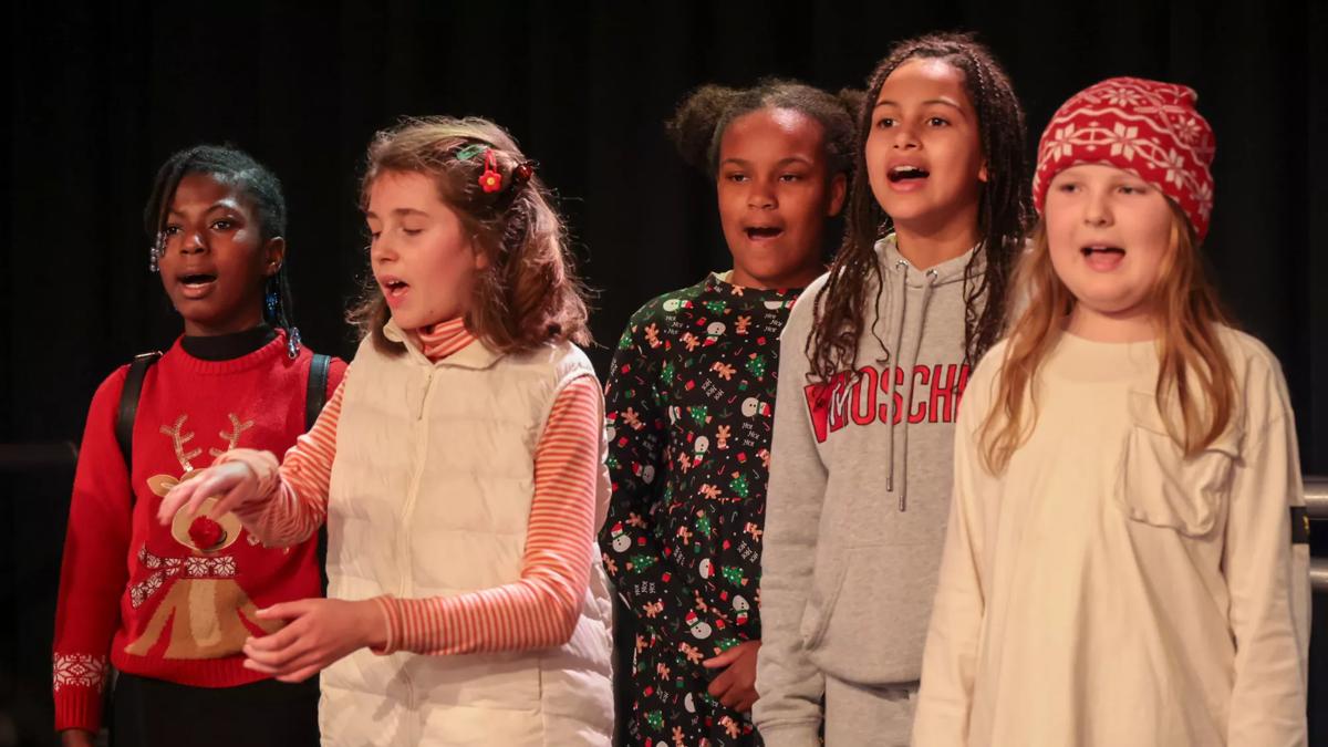 A group of children singing on stage