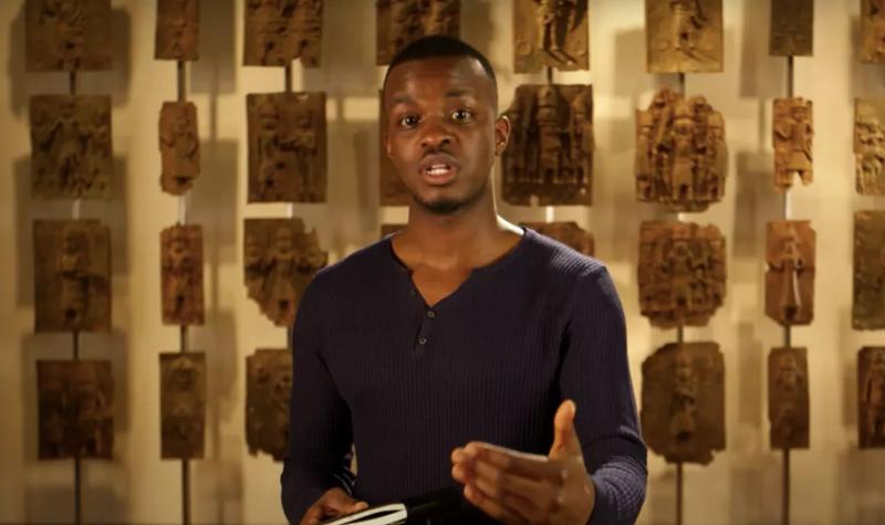 George the Poet reads a poem standing in front of the Benin Bronzes at The British Museum