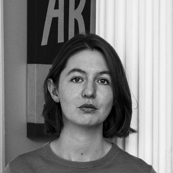 Author Sally Rooney with short brown hair in a t shirt