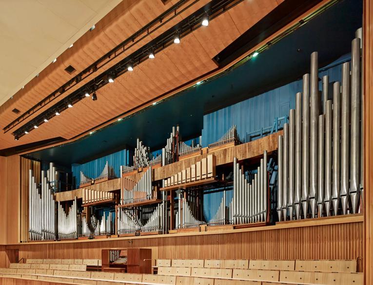 An angled wide view of the Royal Festival Hall organ with pipes on show, above the Royal Festival Hall stage