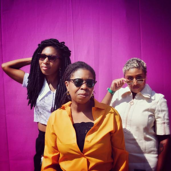 British punk trio, Big Joanie photo shoot with a pink backdrop