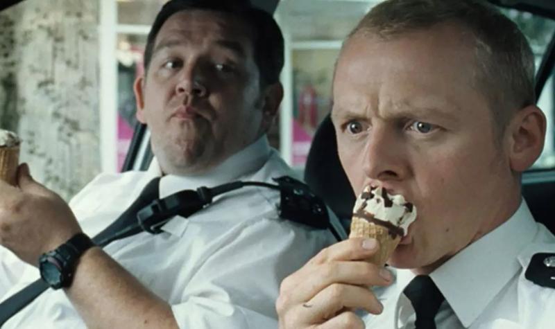 Actors Nick Frost and Simon Pegg in character as policemen, eating Cornetto ice-creams in their car, during filming of Hot Fuzz