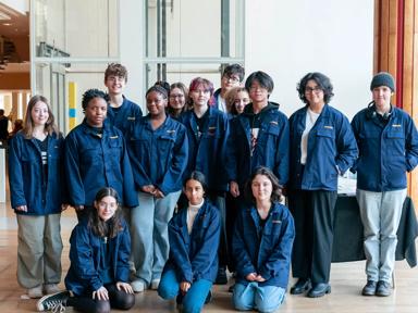 A group of children wearing blue jackets