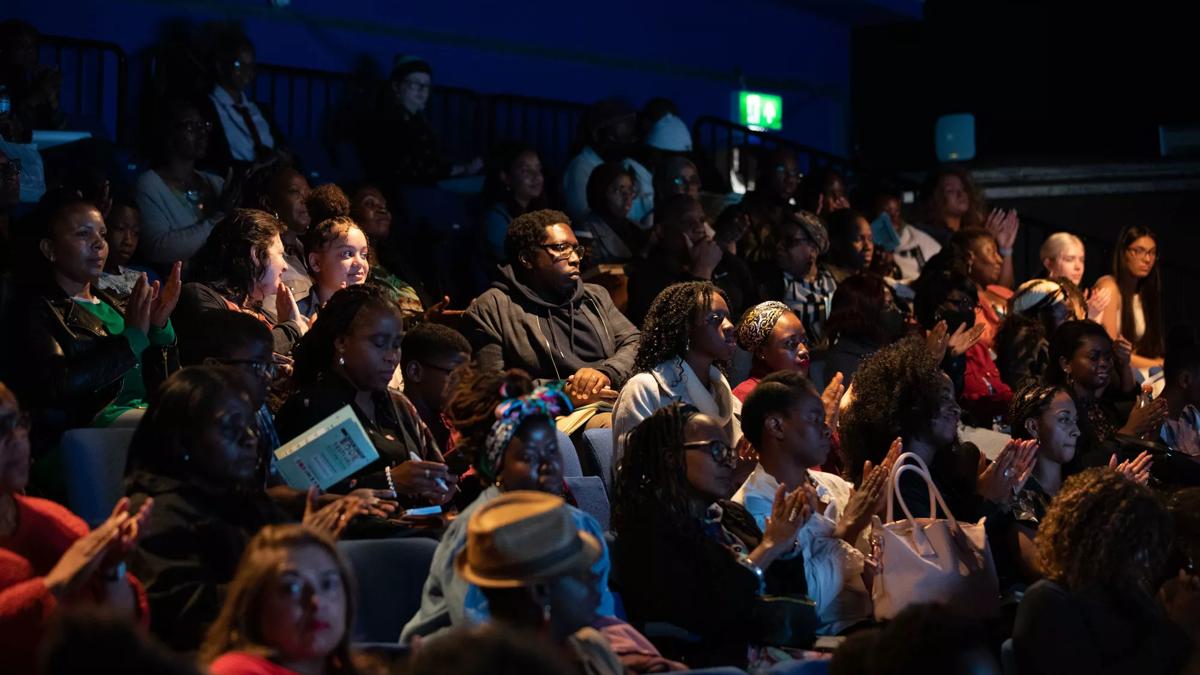 The audience of the Black British Book Festival wait in anticipation for an event to start. 