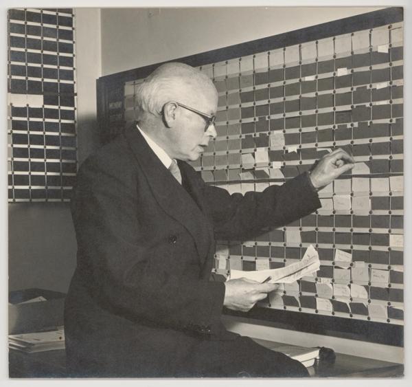 Visitor inspecting documents in the archive