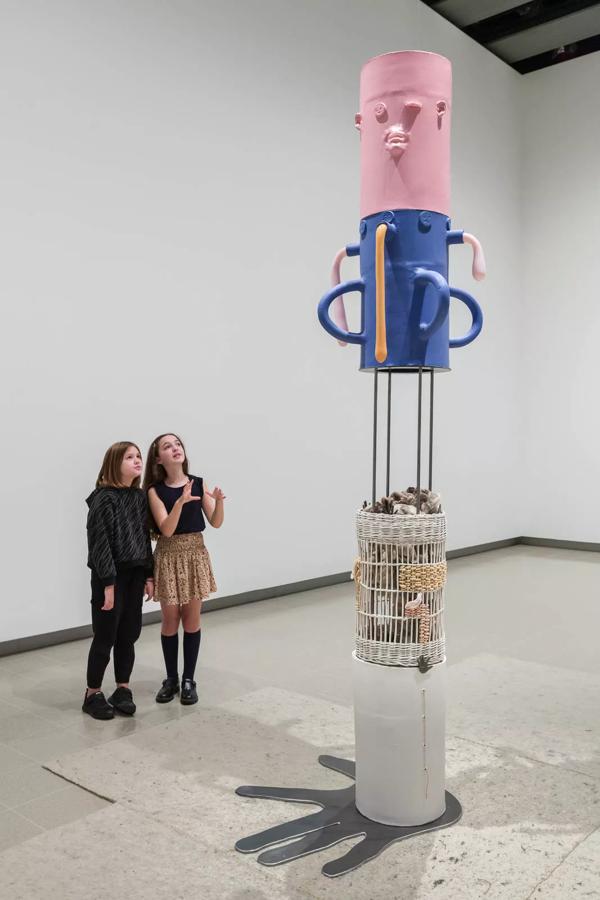 Children looking up at ceramic sculptures with faces. Installation view of Jonathan Baldock, Strange Clay: Ceramics in Contemporary Art at the Hayward Gallery. Photo: Mark Blower. Courtesy the Hayward Gallery.