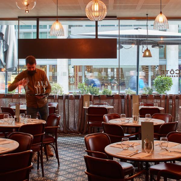 Cote Brasserie interior with tables being set