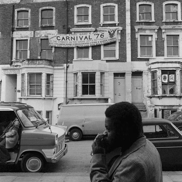 A black man walking at Notting Hill Carnival 1976