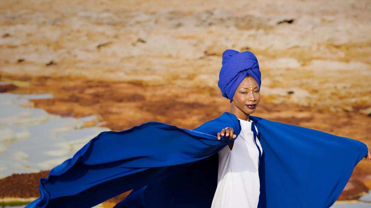 Fatoumara Diawara, Malian singer-songwriter in a blue cape photographed outside