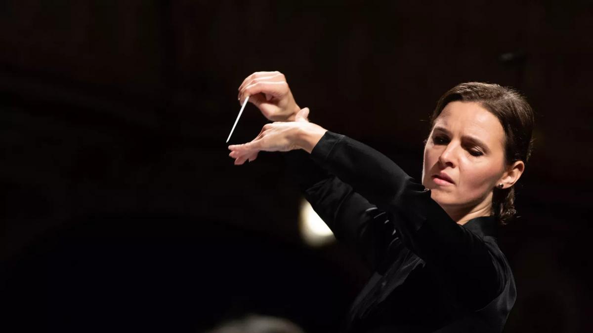 Conductor Oksana Lyniv conducting with her hands in the air