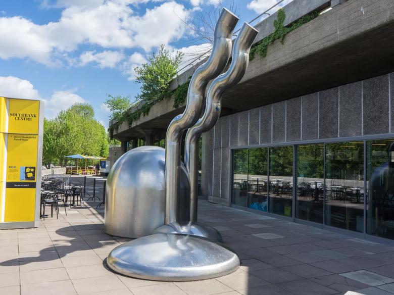 A photograph showing Riverside Terrace at Southbank Centre, with the metal sculpture Zemran in the foreground, next to Queen Elizabeth Hall