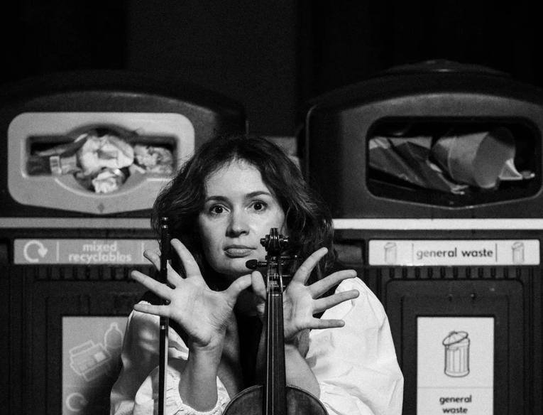 Patricia Kopatchinskaja with her violin by bins