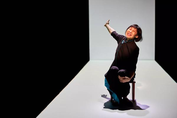 Margaret Leng Tan sitting on a stool