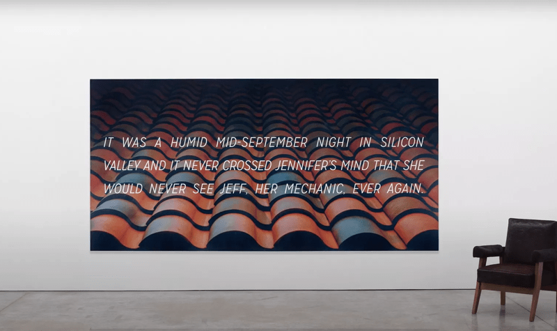 Frieze LA 2020, an artwork by Alex Israel and Brett Easton Ellis which features a sentence written by Ellis over the top of a large stock image of a tiled roof, chosen by Israel, is seen on a canvas on a white wall; there is a chair next to the canvas.