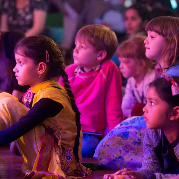 Children watching an event in the audience.