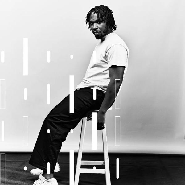 Poet Yomi Sode sitting on a white stool against a white background