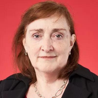 The MP Emma Dent Coad faces the camera in front of a red background
