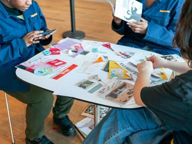 People sat around a table sorting through archival papers