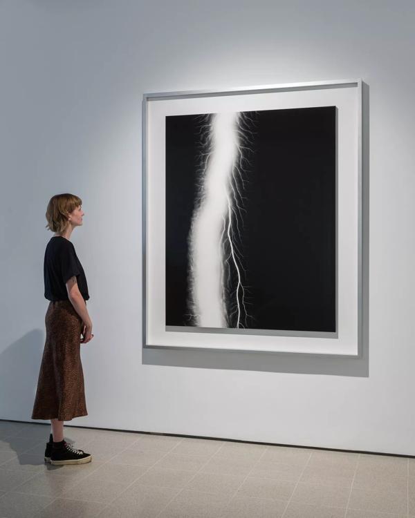A person stands in front of Hiroshi Sugimoto, Lightning Fields 163, 2009.