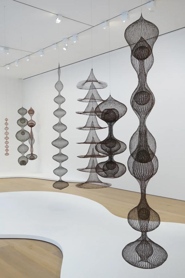 Black 3D geometric shapes hanging from the ceiling