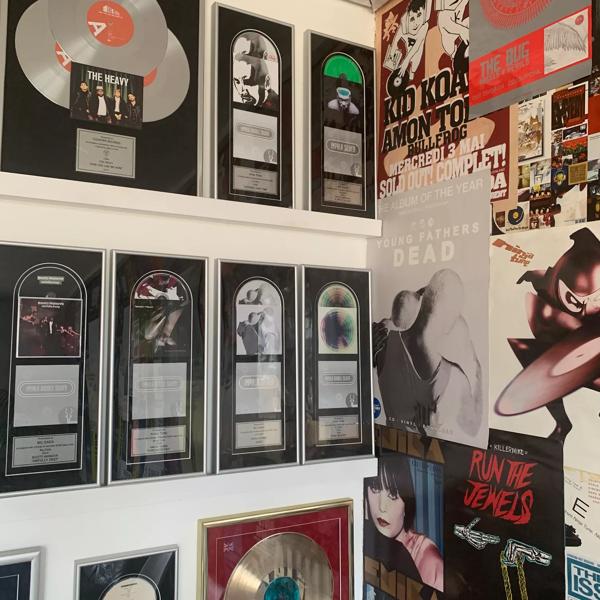 Vinyl record frames cover the left hand of the wall and on the right  album cover posters