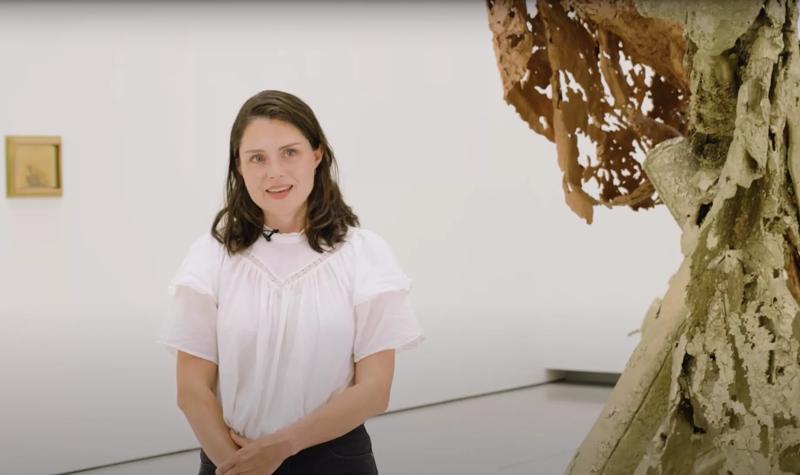 Curator Katie Guggenheim talks to camera whilst standing in the Hayward Gallery exhibition, Matthew Barney: Redoubt