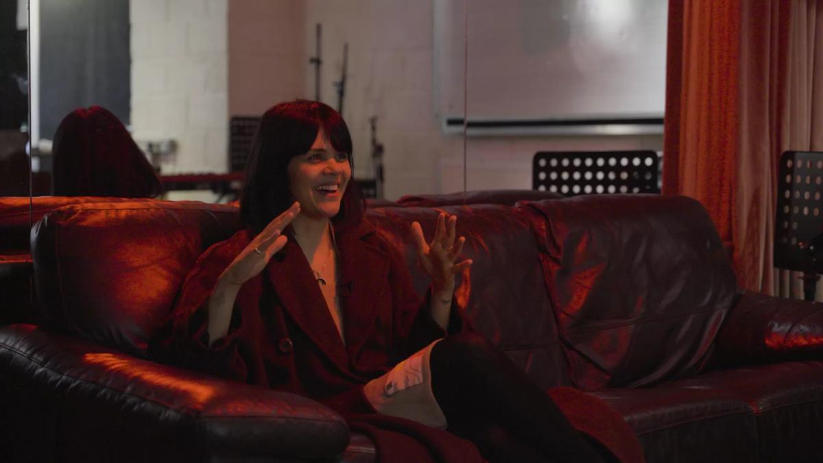 Bat for Lashes Natasha Khan, a woman with short dark hair, being interviewed seated on a sofa in her recording studio