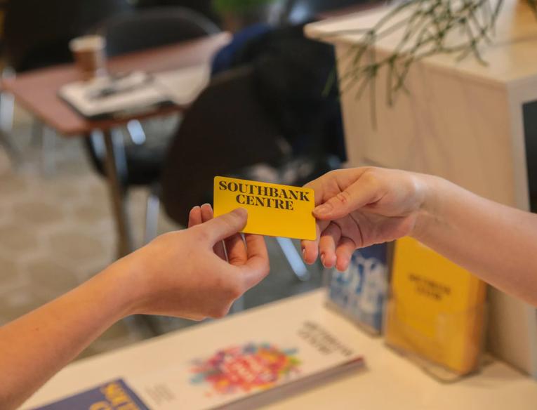 Two hands exchanging Southbank Centre membership card at the Southbank Centre Members Bar