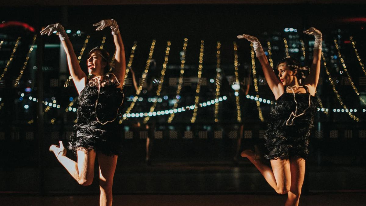 Two dancers in vintage dresses