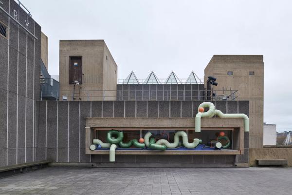 A sculpture made of green pipes on the roof of the Hayward Gallery