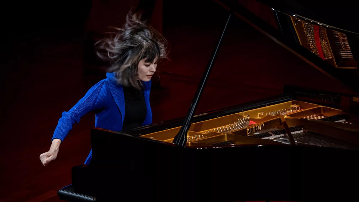 Alice Sara Ott playing the piano with her hair in motion
