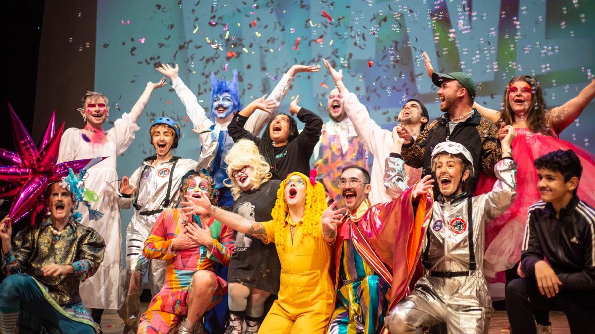 Drag performers waving theirs hands under glitter and bubbles