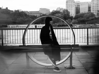 Alice Sara Ott  stood against a red Jeppe Hein bench at the Southbank Centre