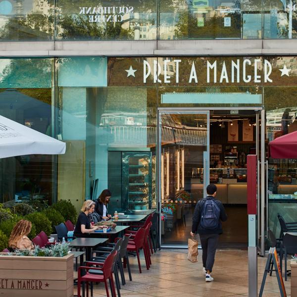 Pret A Manger exterior with outside seating and Royal Festival Hall in the background