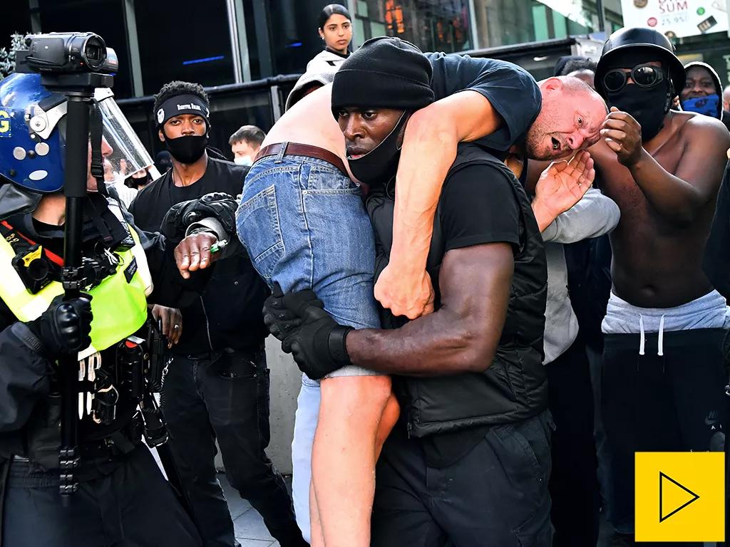 Patrick Hutchinson, a protester, carries a suspected far-right counter-protester who was injured, to safety, near Waterloo station during a Black Lives Matter protest following the death of George Floyd in Minneapolis police custody, in London, Britain, June 13, 2020. Image credit REUTERS/Dylan Martinez 