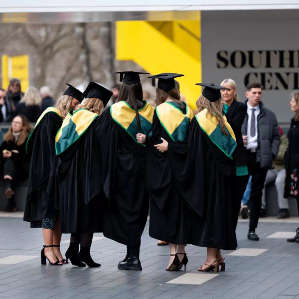 Image of students graduating wearing gowns outside the Royal Festival Hall