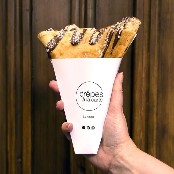 Photo of a banana and nutella crêpe in a takeaway cone served by Crêpes à la carte at Southbank Centre Food Market