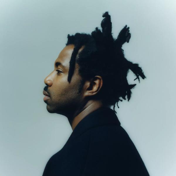 Sampha headshot from the side, they are wearing a black jacket