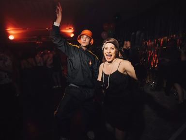 Two people dance at the New Year's Eve Spectacular; a woman in 1920s inspired outfit, a man dressed as a 1990s raver